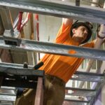 man_on_ladder_ceiling_work_AAE_460